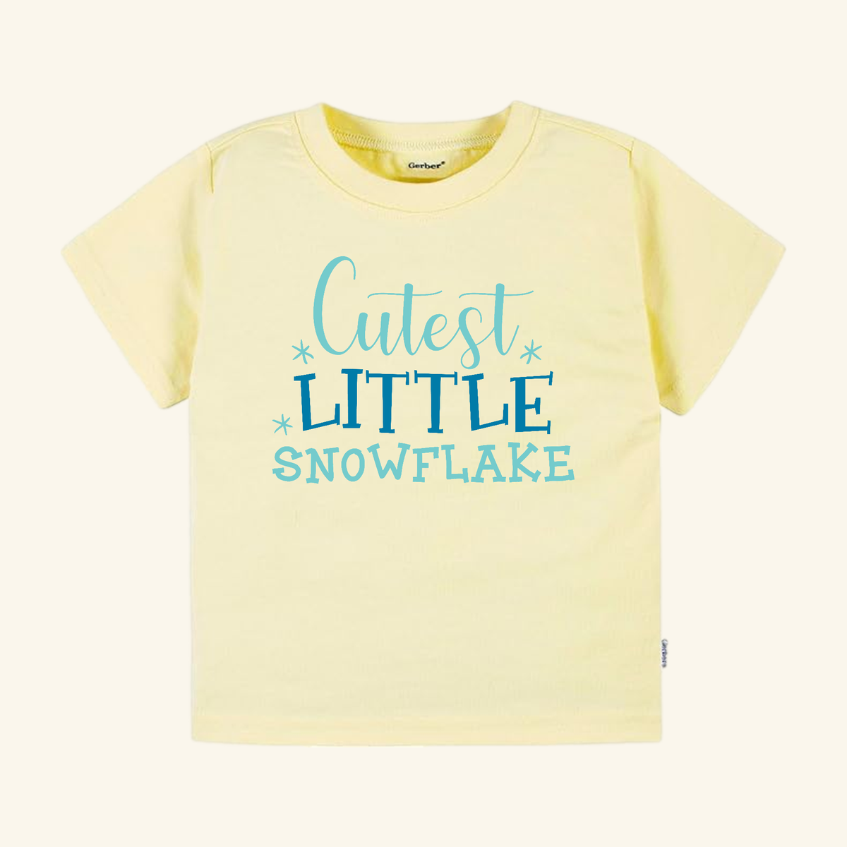 Light yellow Winter Toddler Shirt – Cutest Little Snowflake Tee featuring the text Cutest LITTLE SNOWFLAKE in blue script and block lettering.