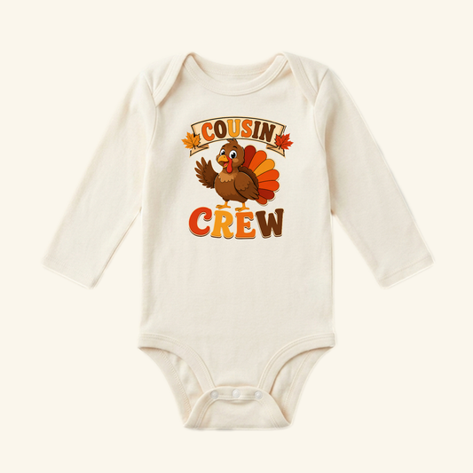 Toodleroos Thanksgiving Cousin Baby Onesie – Cousin Crew Turkey Bodysuit featuring a long-sleeve design with a cartoon turkey and the text COUSIN CREW printed on the front.