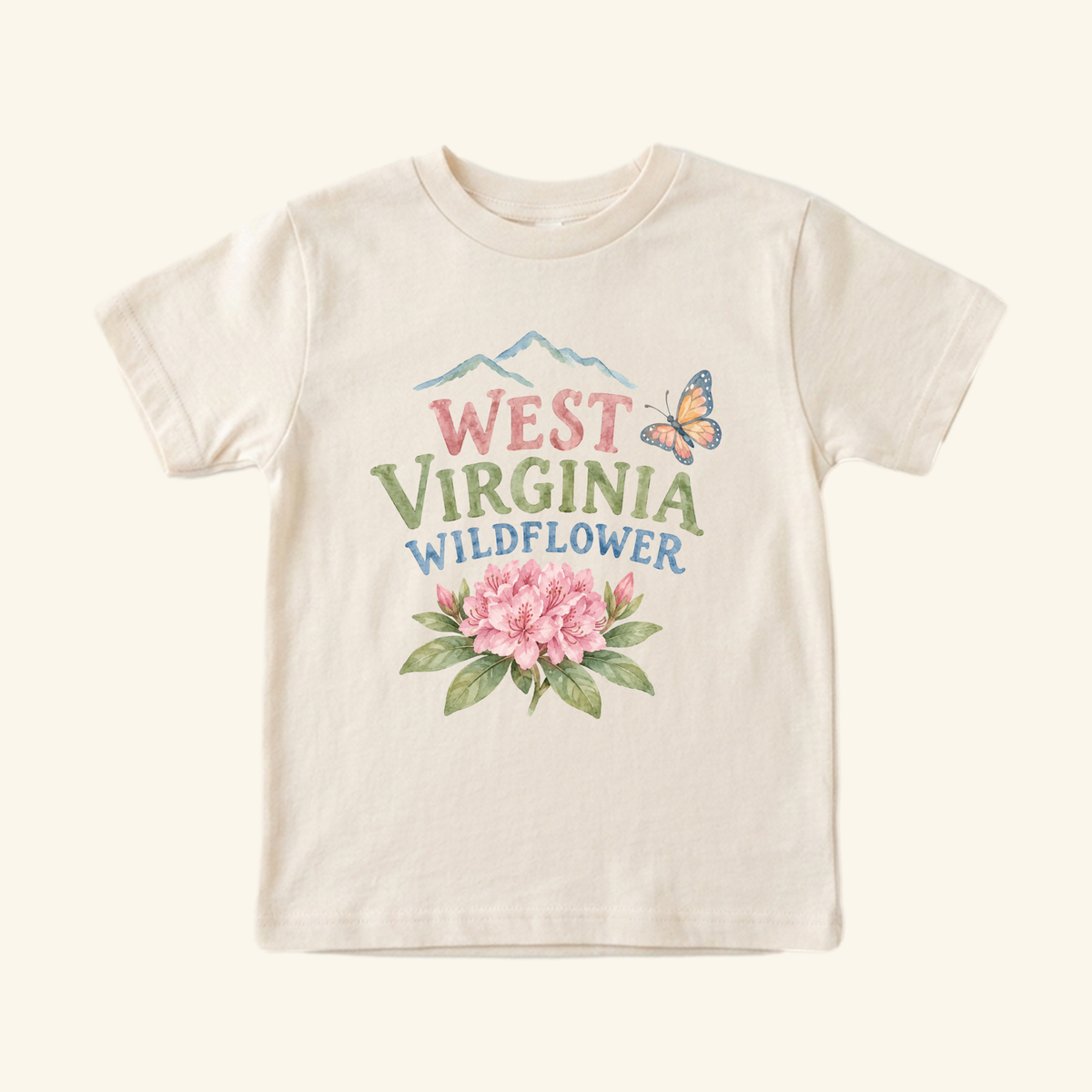 Cream-colored West Virginia Toddler Shirt – Wildflower Rhododendron Tee featuring a graphic of a rhododendron, a butterfly, and mountains with the text West Virginia Wildflower.
