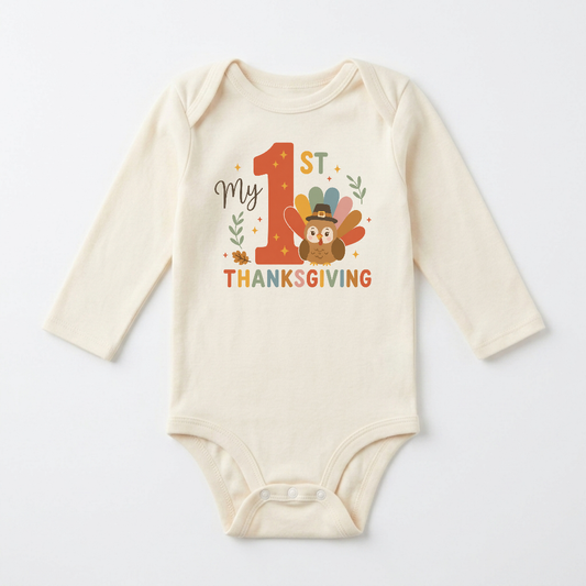 Dress your little one in the Toodleroos Long-Sleeve Baby’s First Thanksgiving Onesie – My 1st Thanksgiving Turkey: a cream-colored outfit featuring “My 1st Thanksgiving” text and an adorable turkey in a pilgrim hat, surrounded by leaves and stars—the perfect choice for your baby’s first Thanksgiving celebration.