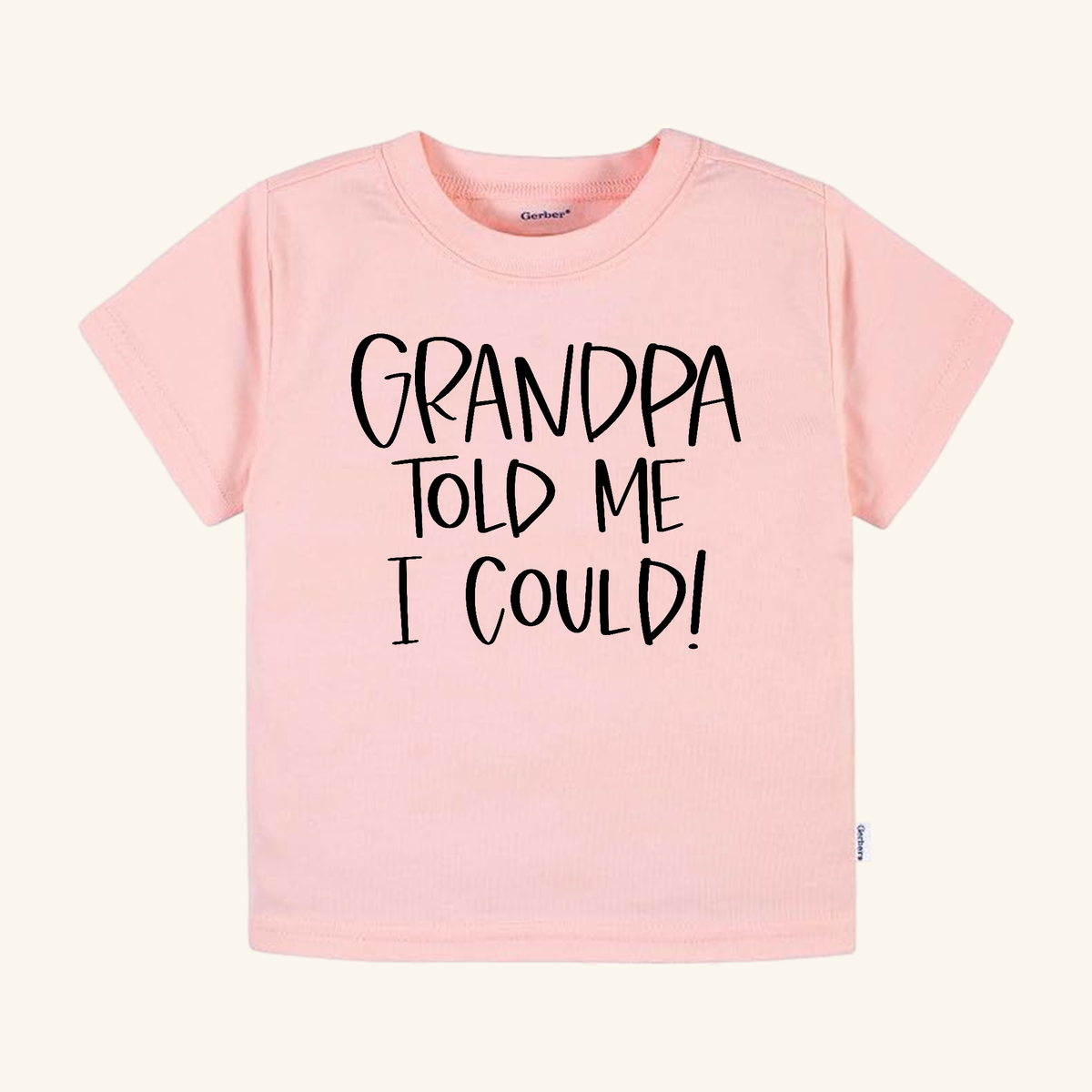 Light pink Funny Grandpa Toddler Shirt – Grandpa Told Me I Could Short-Sleeve Tee with the text GRANDPA TOLD ME I COULD! printed in black letters.