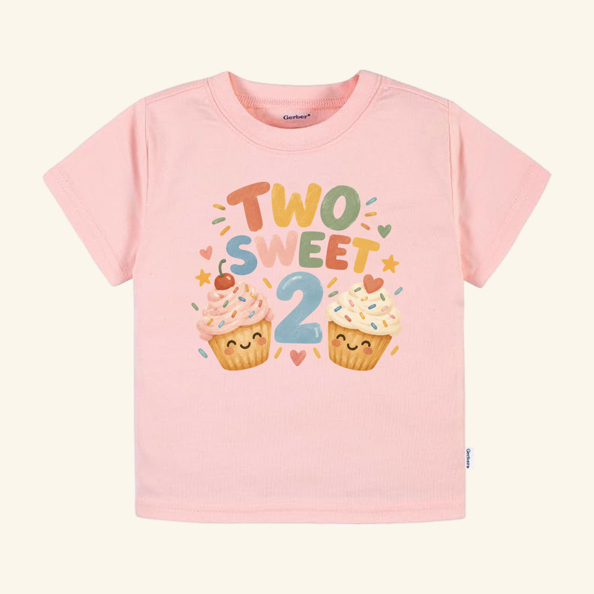 Light pink Two Sweet 2nd Birthday Toddler Shirt – Smiling Cupcake Short-Sleeve Tee featuring two smiling cupcakes, sprinkles, and the text TWO SWEET 2.