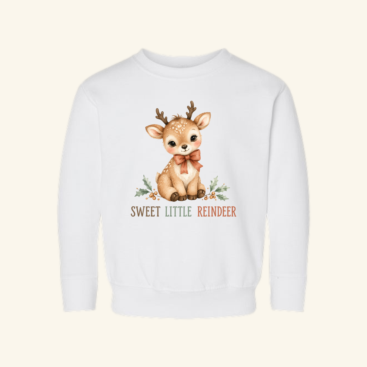White long-sleeved Sweet Little Reindeer Toddler Sweatshirt – Christmas Pullover featuring a watercolor illustration of a fawn with a bow, holly leaves, and the text SWEET LITTLE REINDEER.