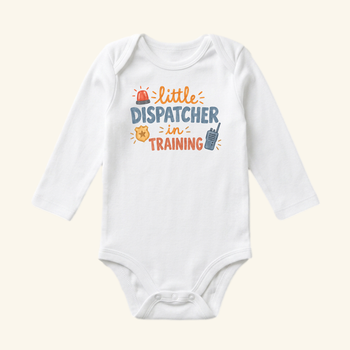 White long-sleeve Little Dispatcher in Training Baby Onesie with little DISPATCHER in TRAINING text surrounded by illustrations of a siren, a badge, and a walkie-talkie.