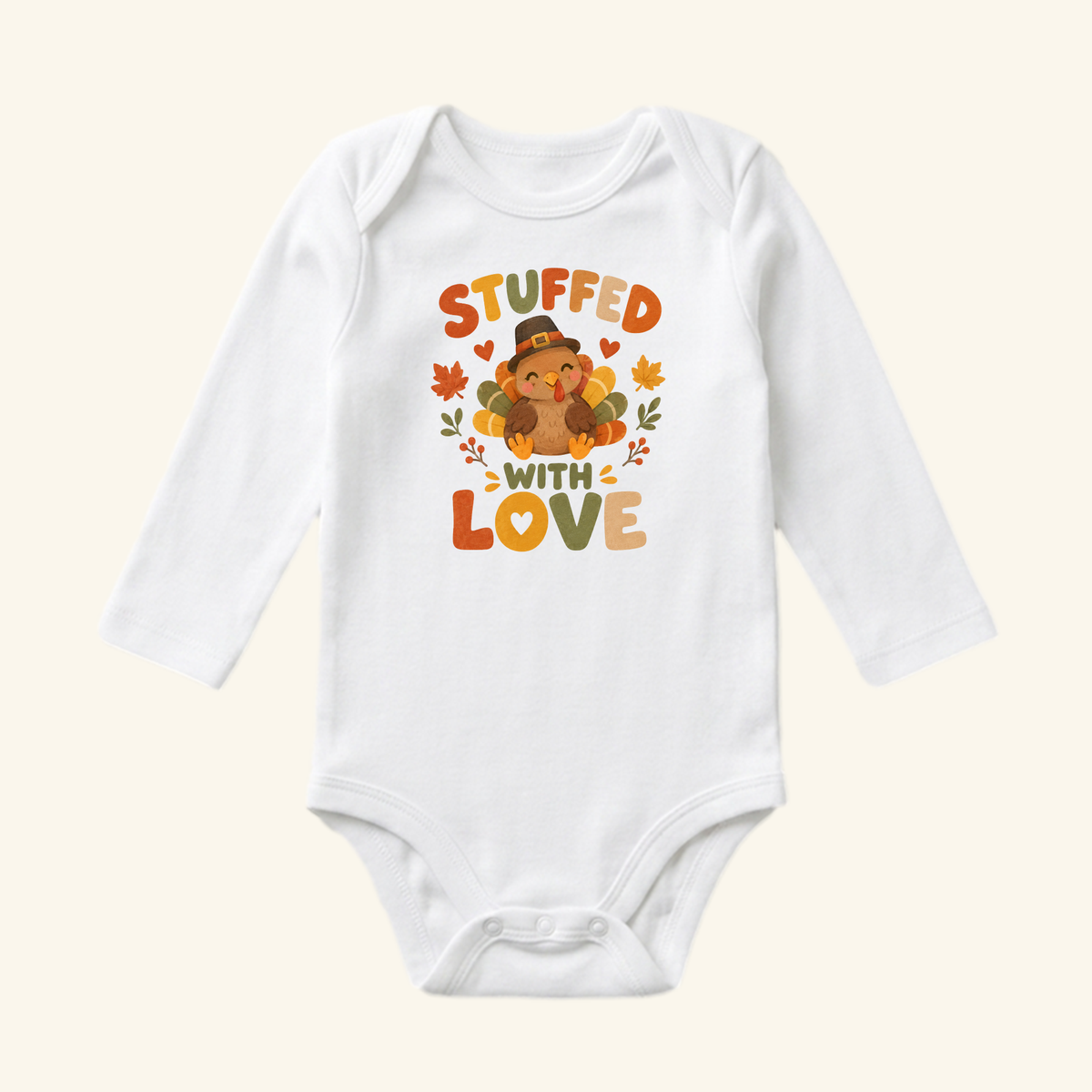 White long-sleeve Stuffed With Love Baby Onesie – Thanksgiving Turkey Bodysuit featuring a cartoon turkey wearing a pilgrim hat surrounded by autumn leaves, perfect for a baby’s first Thanksgiving.
