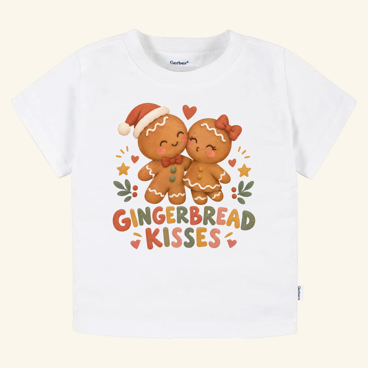 Gingerbread Kisses Toddler Shirt – Cute Christmas Gingerbread Couple Tee featuring a white short-sleeved shirt with a graphic of two gingerbread cookies kissing surrounded by hearts and stars, with the text Gingerbread Kisses below.
