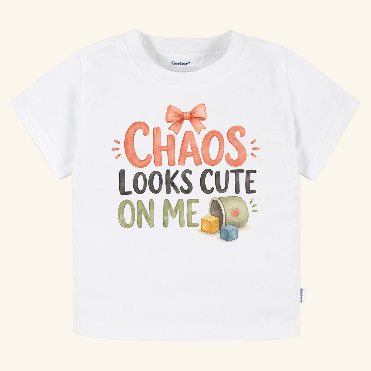 Chaos Looks Cute on Me Toddler Shirt featuring a white toddler tee with a pink bow, building blocks, a tipped-over toy bucket, and the text CHAOS LOOKS CUTE ON ME.
