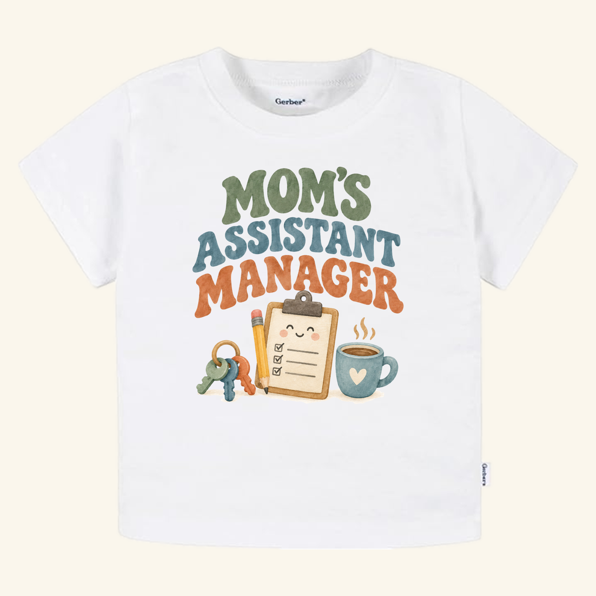 White Mom’s Assistant Manager Toddler Shirt – Funny Retro Mom Tee featuring text above a cartoon clipboard, pencil, keys, and coffee mug.