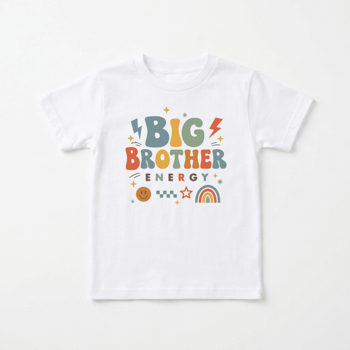 Introducing the Toodleroos Big Brother Energy Toddler Shirt – Retro Graphic Design: a white tee adorned with vibrant, playful text that says “Big Brother Energy,” surrounded by decorative lightning bolts, stars, a rainbow, a smiley face, and a checkerboard pattern. This fun and colorful shirt is perfect for making a memorable pregnancy announcement or letting your toddler celebrate sibling pride in style!.
