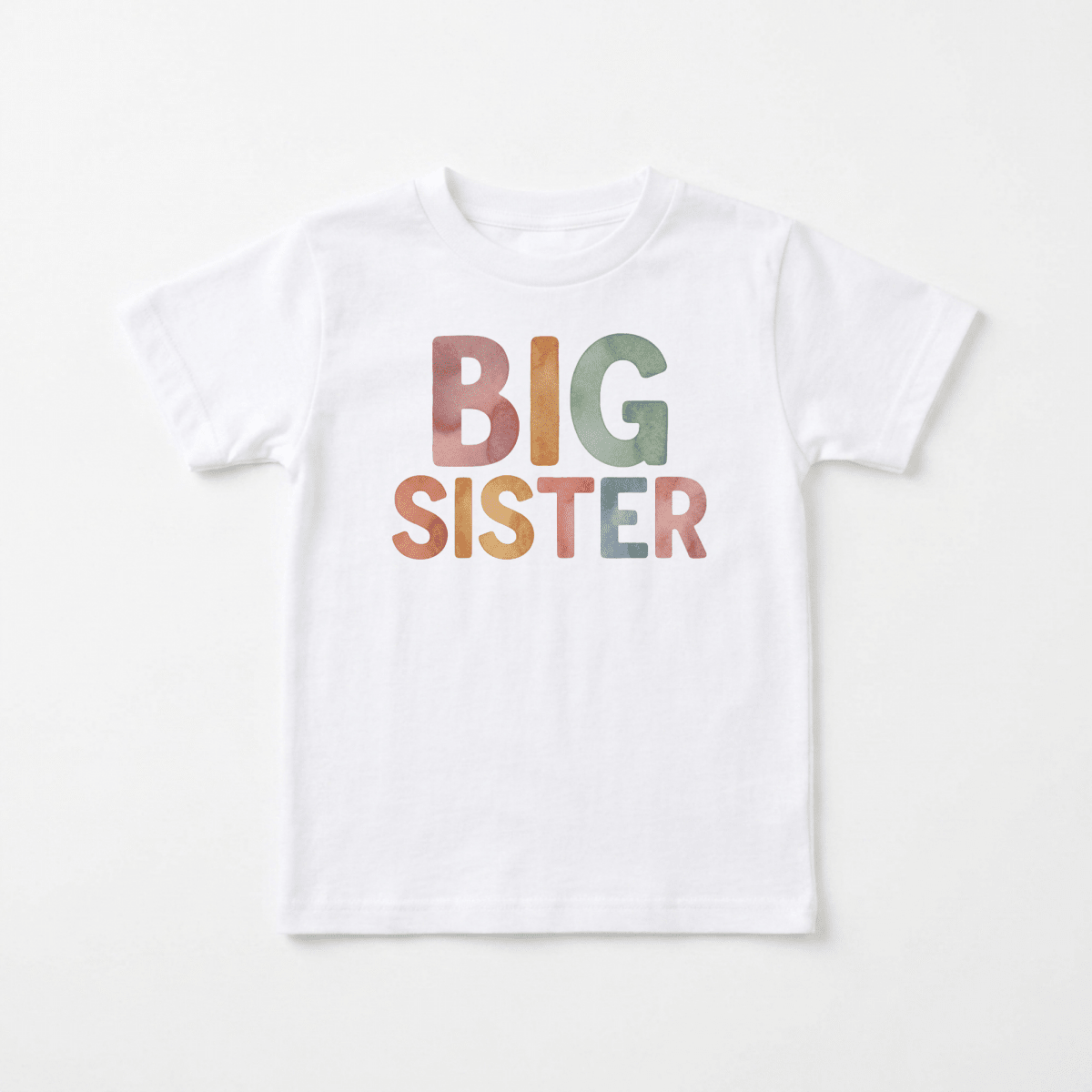 The Toodleroos Big Sister Toddler Shirt – Colorful Retro Design features “BIG SISTER” printed in large, vibrant uppercase letters in shades of orange, red, green, and blue on the front of a white shirt. Perfect for pregnancy announcements, this adorable top is displayed laid flat against a simple background.
