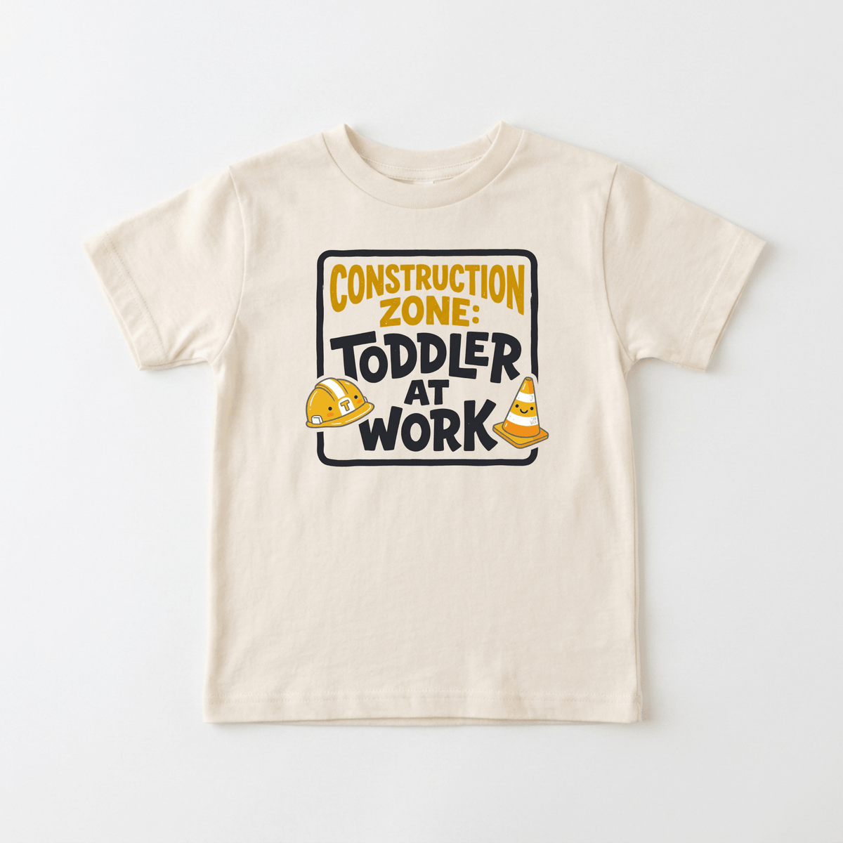 Dress your little builder in the Toodleroos Construction Zone Toddler at Work Shirt – Little Builder Tee, a beige kids’ T-shirt featuring a “Construction Zone: Toddler at Work” sign graphic with a construction helmet and orange traffic cone—perfect as a toddler construction shirt or construction birthday outfit.