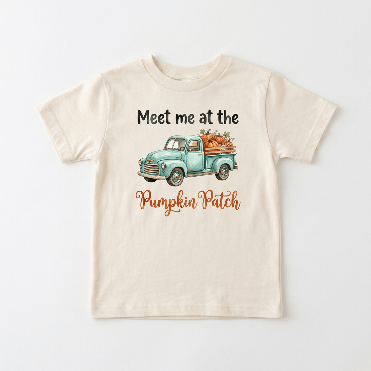 The Toodleroos Meet Me at the Pumpkin Patch Kids Shirt – Fall Truck Tee features a beige base with a teal watercolor vintage truck loaded with pumpkins and “Meet me at the Pumpkin Patch” in black and orange lettering on the front, making it the perfect cozy fall kids tee or pumpkin patch shirt.