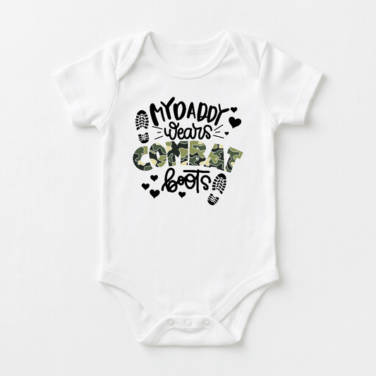 Dress your little one in the Toodleroos “My Daddy Wears Combat Boots Baby Onesie – Camo Design,” featuring a white bodysuit with the phrase “My Daddy Wears Combat Boots” in bold black and camouflage lettering, accented by small heart and boot print graphics. This adorable military baby onesie makes a perfect gift for any military dad.