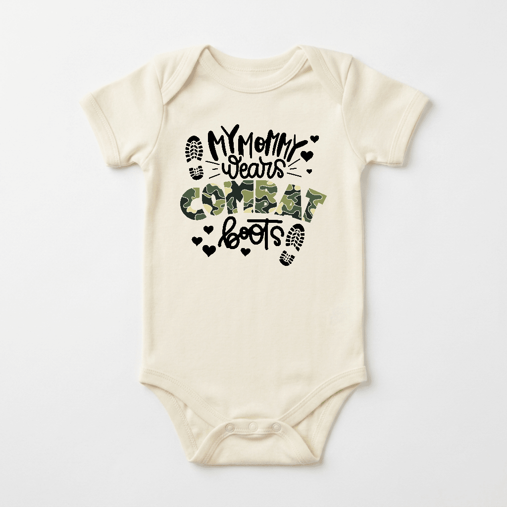 Dress your little one in the Toodleroos “My Mommy Wears Combat Boots Baby Onesie – Camo Design”—a cream-colored military baby bodysuit showcasing bold black and green camouflage text, playful heart shapes, and boot prints. The perfect gift for a proud military mom!.