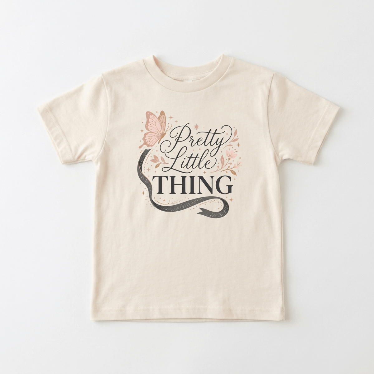 The Toodleroos Pretty Little Thing Toddler Tee – Cute Butterfly Girls Shirt features a beige base with a butterfly and floral graphic, showcasing a snake, butterfly, the phrase “Pretty Little Thing,” and charming star and floral details—ideal as a stylish girls shirt or toddler tee.