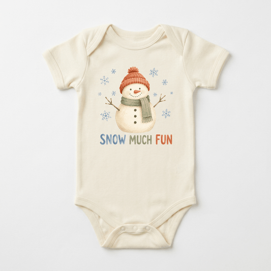 The Toodleroos Snow Much Fun Snowman Baby Onesie is an ivory winter bodysuit showcasing a cheerful snowman in a red hat and green scarf, surrounded by playful snowflakes. “SNOW MUCH FUN” is printed below in colorful letters, making it perfect for baby’s first winter.