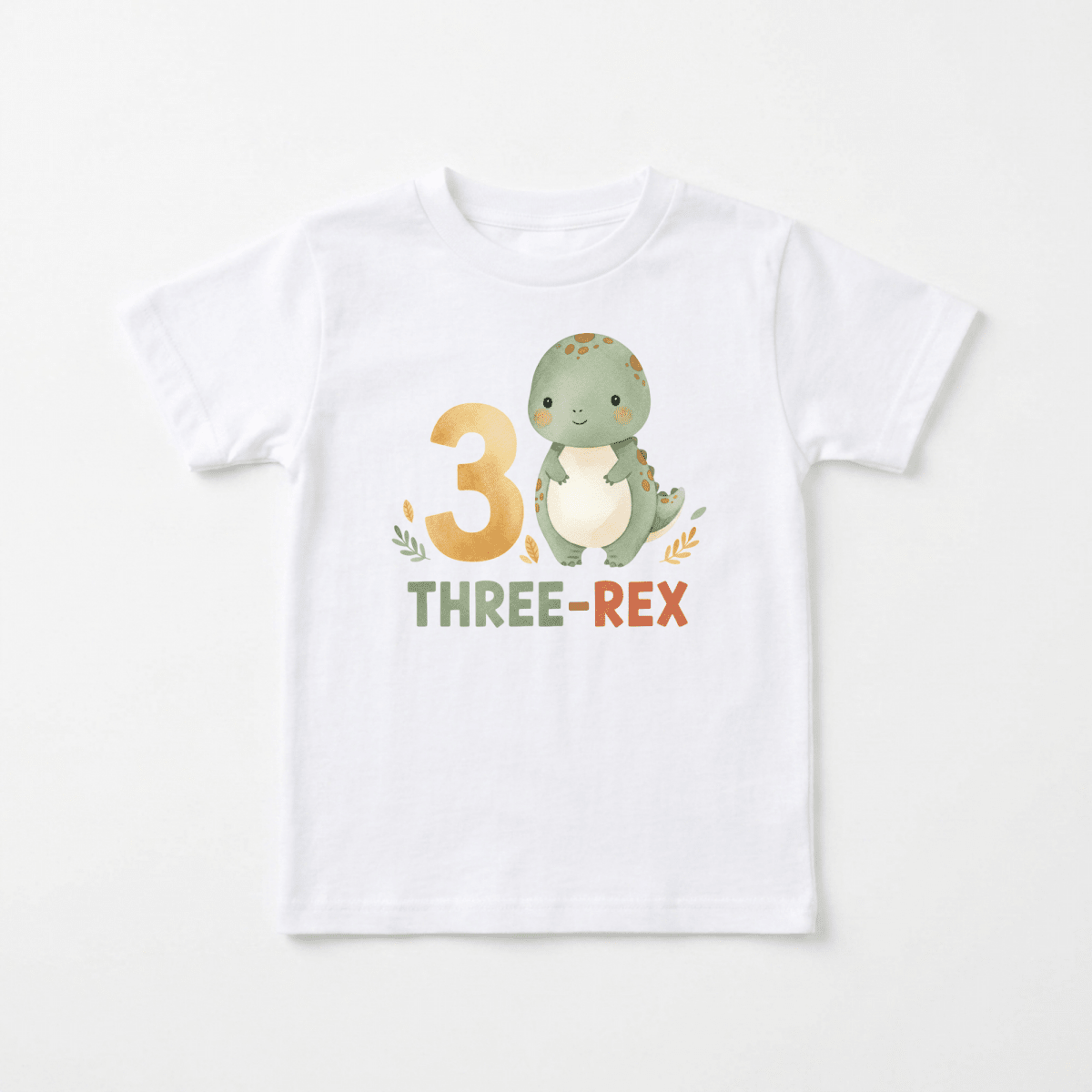 The Toodleroos 3rd Birthday Dinosaur Toddler Shirt – Three-Rex Short-Sleeve Tee is a white kids shirt featuring a cute green dinosaur, the number 3, and the words “THREE-REX” in playful green and orange text on the front—perfect as a fun Three-Rex toddler shirt or as a special 3rd birthday dinosaur tee for your little one.