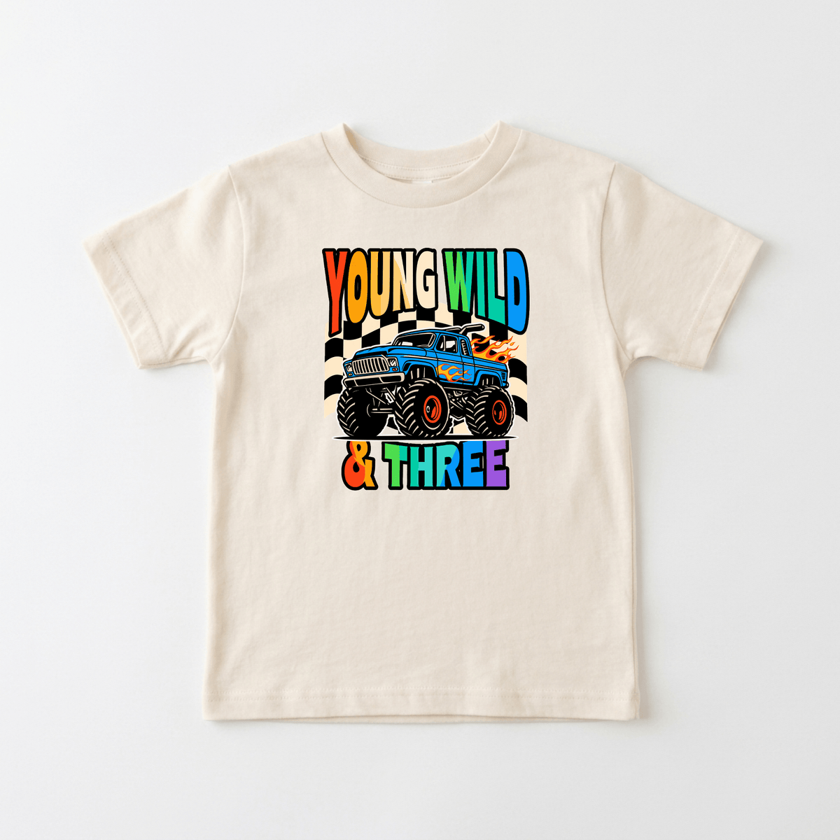 Celebrate your little one’s big day with the Toodleroos Young Wild & Three Toddler Shirt – Monster Truck 3rd Birthday Tee! This beige T-shirt features a vibrant graphic of a blue monster truck and bold, colorful lettering in orange, yellow, green, blue, and purple that reads “YOUNG WILD & THREE.” It’s the perfect toddler shirt for a fun 3rd birthday celebration.