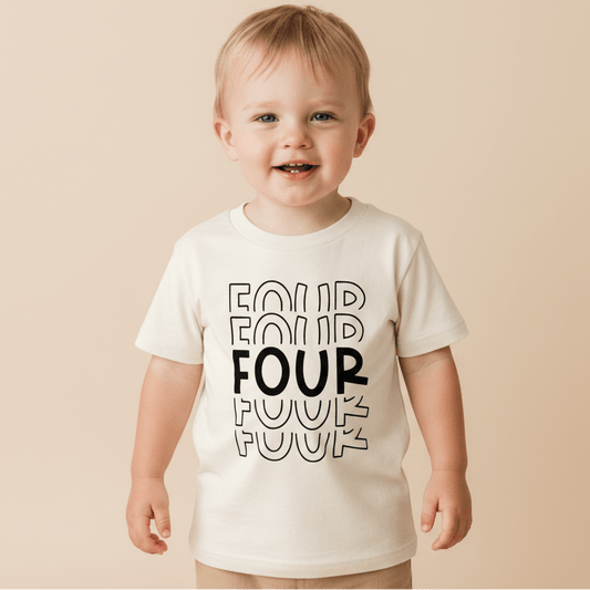 A smiling young child wears the Toodleroos 4th Birthday Kids Shirt—a cream tee with “FOUR” printed four times in bold, outlined letters—standing against a beige background for a perfect gender-neutral birthday outfit.