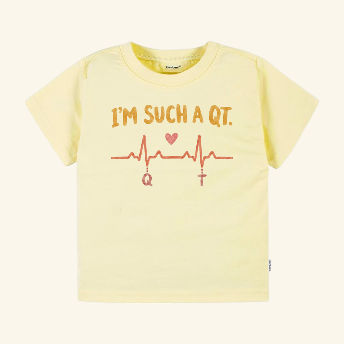 Pale yellow I’m Such a QT Toddler Shirt featuring an EKG heartbeat line with a heart icon and the text IM SUCH A QT.