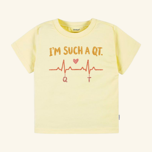 Pale yellow I’m Such a QT Toddler Shirt featuring an EKG heartbeat line with a heart icon and the text IM SUCH A QT.