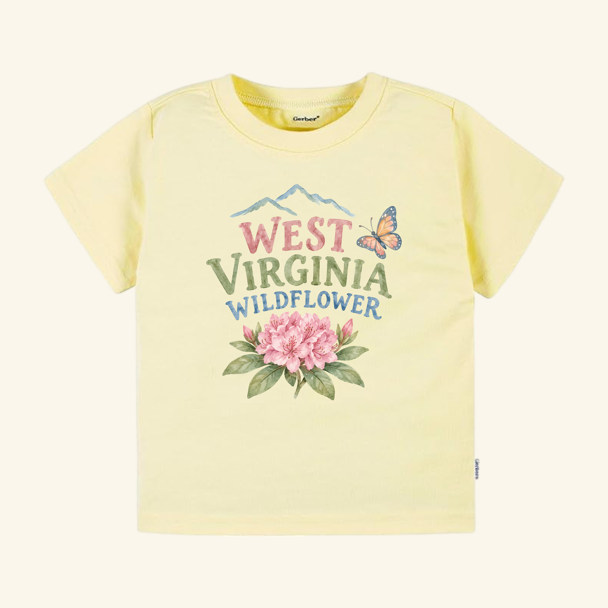 Light yellow West Virginia Toddler Shirt – Wildflower Rhododendron Tee featuring a graphic of mountains, a butterfly, rhododendron flowers, and the text West Virginia Wildflower.