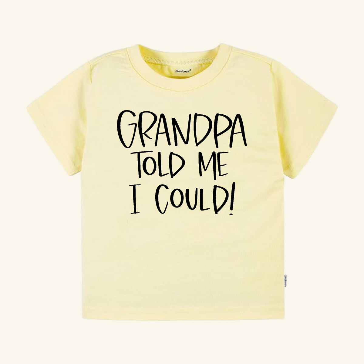 Light yellow short-sleeve Funny Grandpa Toddler Shirt – Grandpa Told Me I Could, featuring the text GRANDPA TOLD ME I COULD! in black letters.