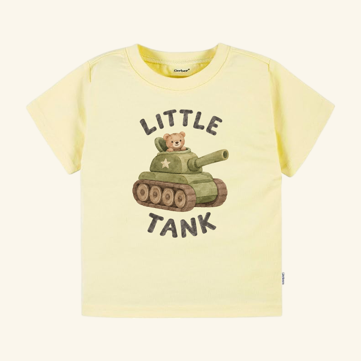 A pale yellow Little Tank Toddler Shirt featuring a graphic of a teddy bear inside a green army tank with the text LITTLE TANK above and below the design.