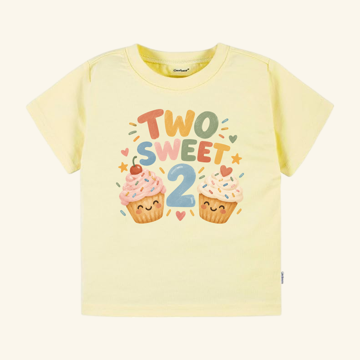 Pale yellow Two Sweet 2nd Birthday Toddler Shirt – Smiling Cupcake Short-Sleeve Tee featuring the text TWO SWEET above the number 2 and two smiling cupcake illustrations.
