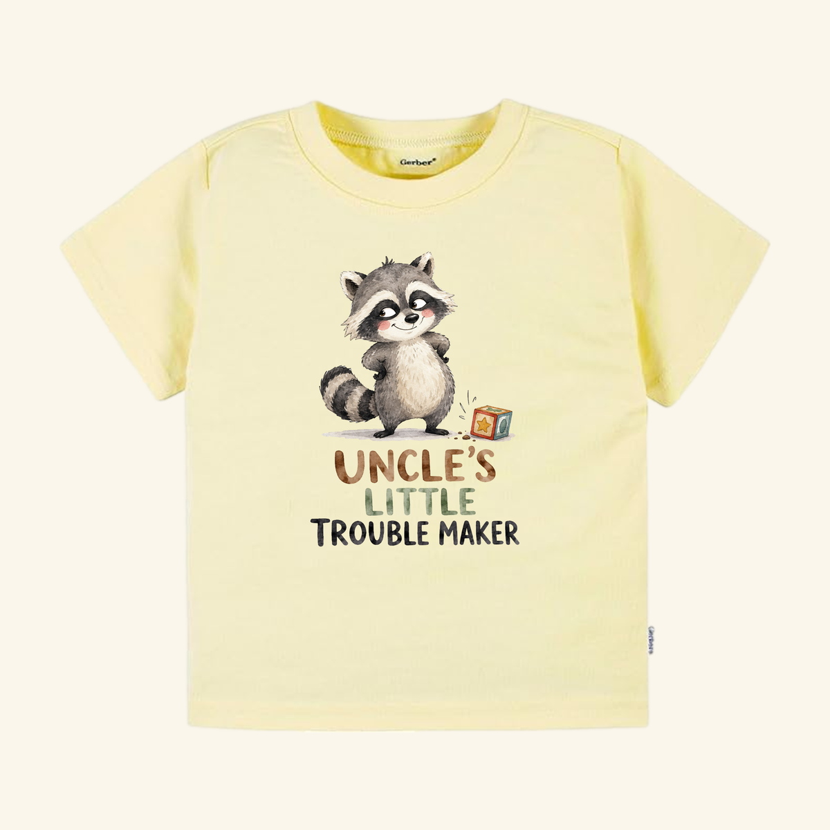 Pale yellow Funny Uncle Toddler Shirt – Uncle’s Little Troublemaker Tee featuring a watercolor raccoon illustration and the text, Uncle’s little troublemaker.