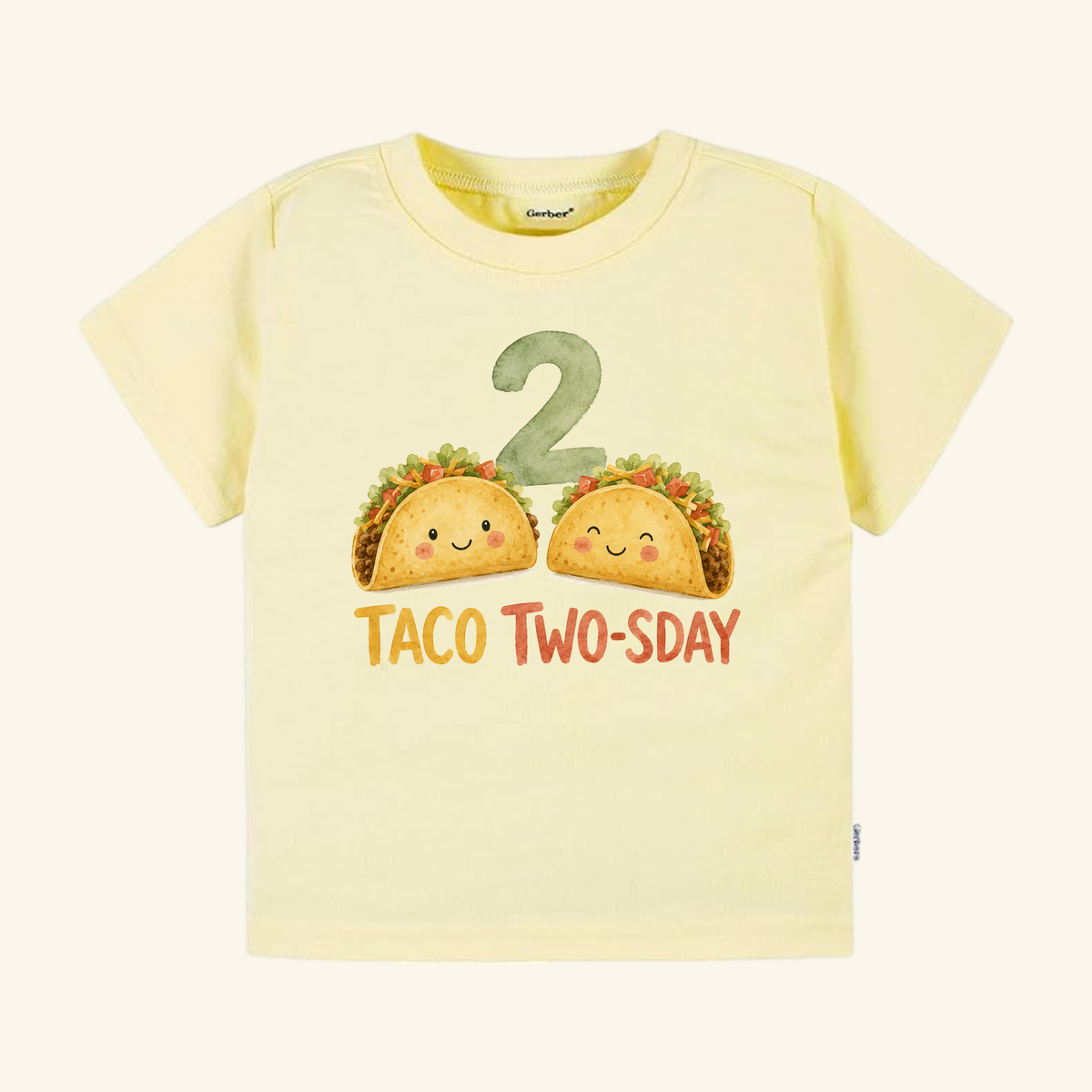 Pale yellow Toodleroos Taco Two-sday 2nd Birthday Toddler Shirt – Short-Sleeve Tee featuring two illustrated tacos with faces, the number 2, and the text TACO TWO-SDAY.