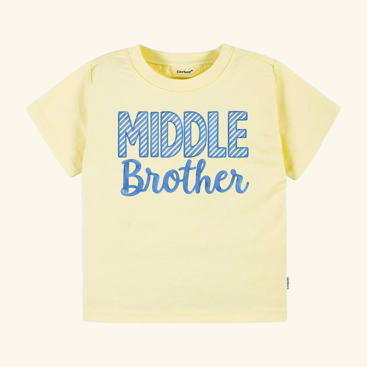 Toodleroos Middle Brother Toddler Shirt – Blue Striped Letters Sibling Tee featuring a pale yellow shirt with MIDDLE in blue-striped letters above Brother in blue script.