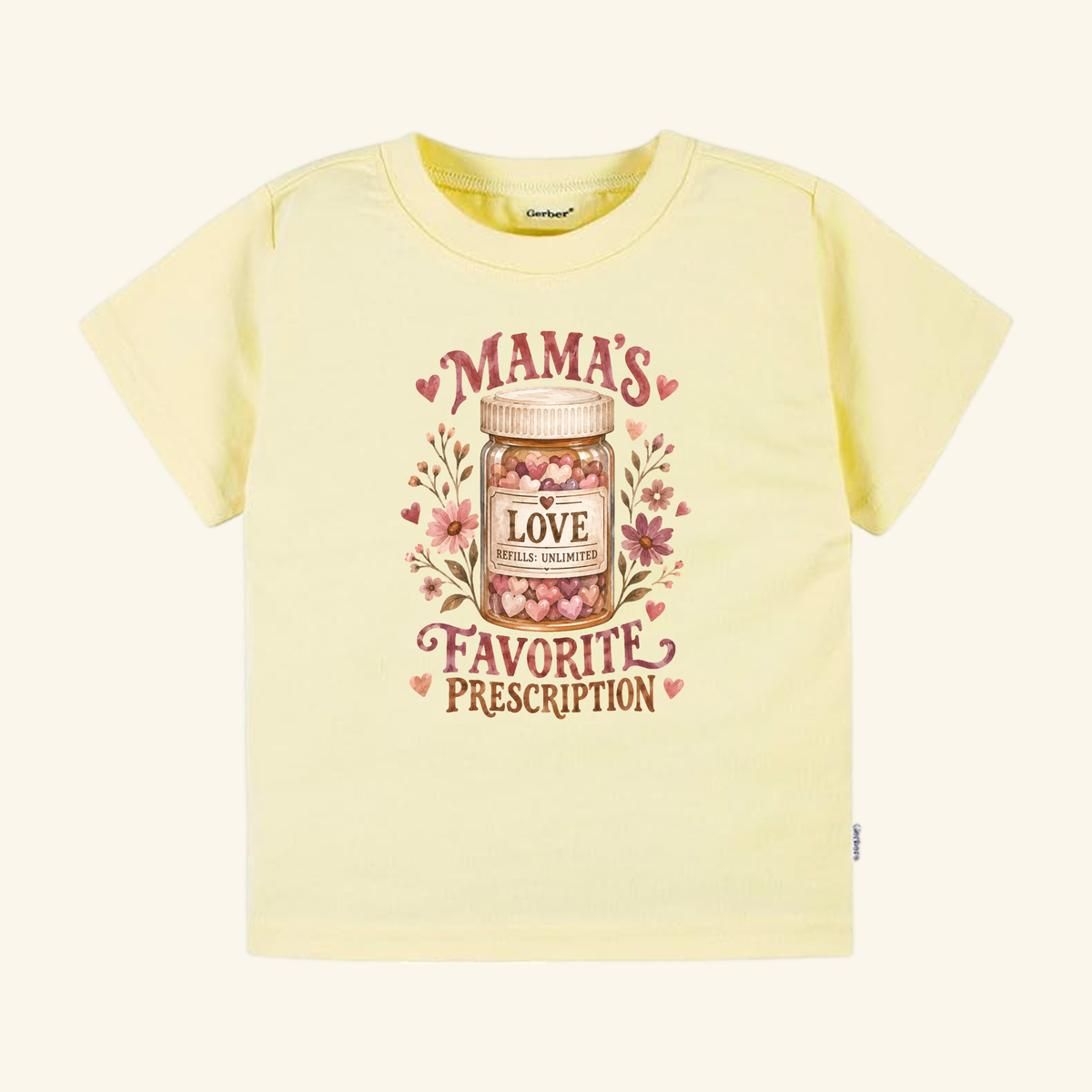 Pale yellow Mama’s Favorite Prescription Toddler Shirt featuring a graphic of a medicine bottle filled with heart-shaped candies, labeled Mamas Favorite Prescription and Love Refills: Unlimited.