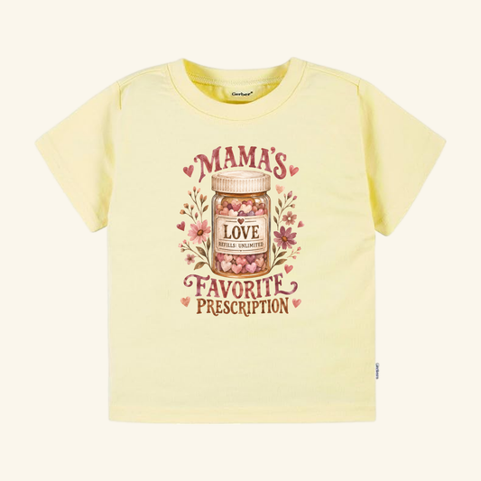 Pale yellow Mama’s Favorite Prescription Toddler Shirt featuring a graphic of a medicine bottle filled with heart-shaped candies, labeled Mamas Favorite Prescription and Love Refills: Unlimited.
