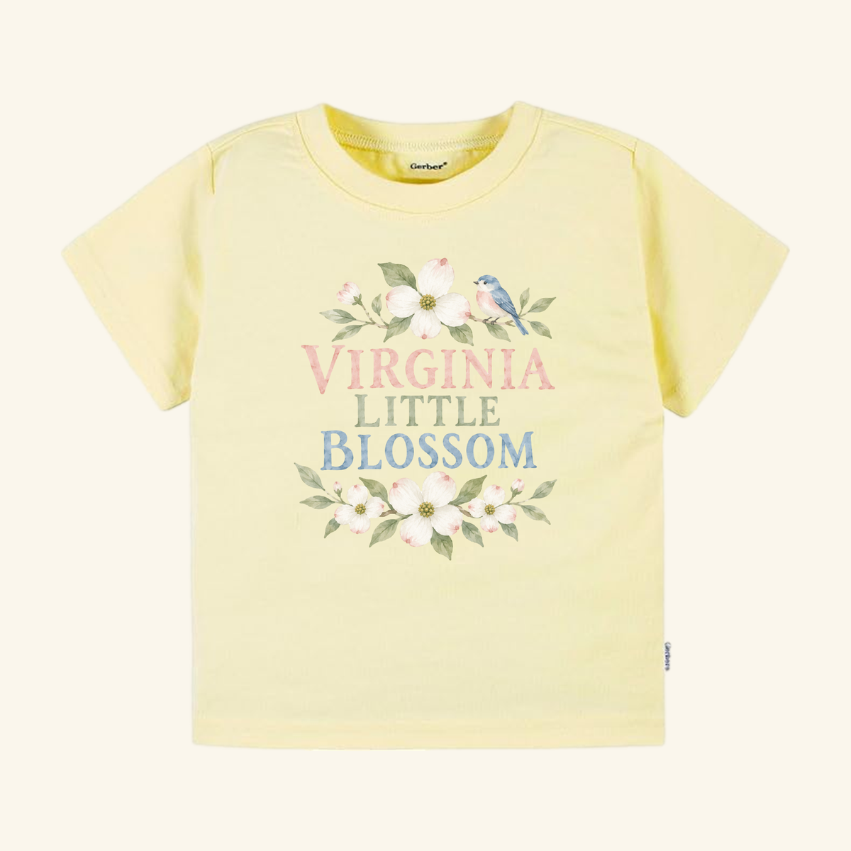 Pale yellow Virginia Toddler Shirt – Little Blossom Dogwood Floral Tee featuring a dogwood floral design, a small bird, and the text VIRGINIA LITTLE BLOSSOM.