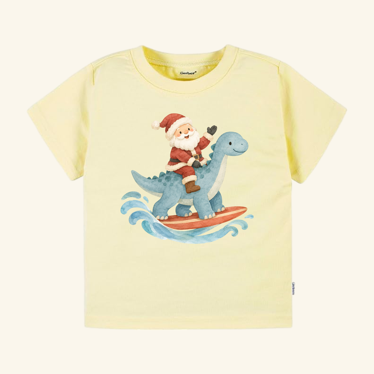 Light yellow Santa Surfing Dinosaur Toddler Shirt – Christmas Beach Tee featuring a watercolor illustration of Santa Claus surfing on a blue dinosaur.