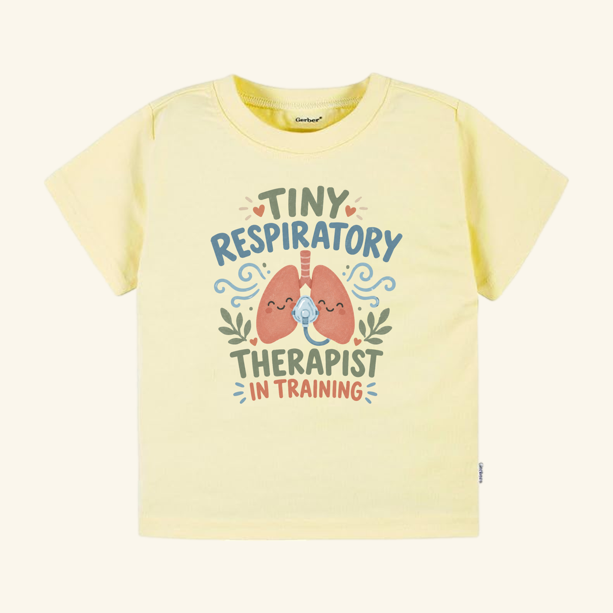 Pale yellow Tiny Respiratory Therapist in Training Toddler Shirt featuring a graphic of two cartoon lungs wearing oxygen masks and the text Tiny Respiratory Therapist In Training.