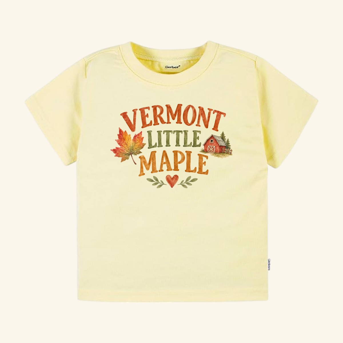 Pale yellow Toodleroos Vermont Toddler Shirt – Little Maple Fall Foliage Barn Tee featuring the text Vermont Little Maple with a watercolor maple leaf, a small red barn, and a heart graphic.