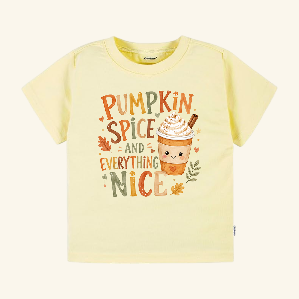 Pale yellow Toodleroos Pumpkin Spice and Everything Nice Toddler Shirt – Fall Latte Tee featuring a graphic of a cute latte with whipped cream and a cinnamon stick.