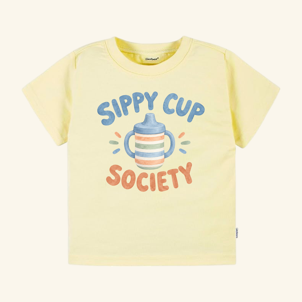 Pale yellow Sippy Cup Society Toddler Shirt featuring a cute illustration of a sippy cup surrounded by the text Sippy Cup Society.