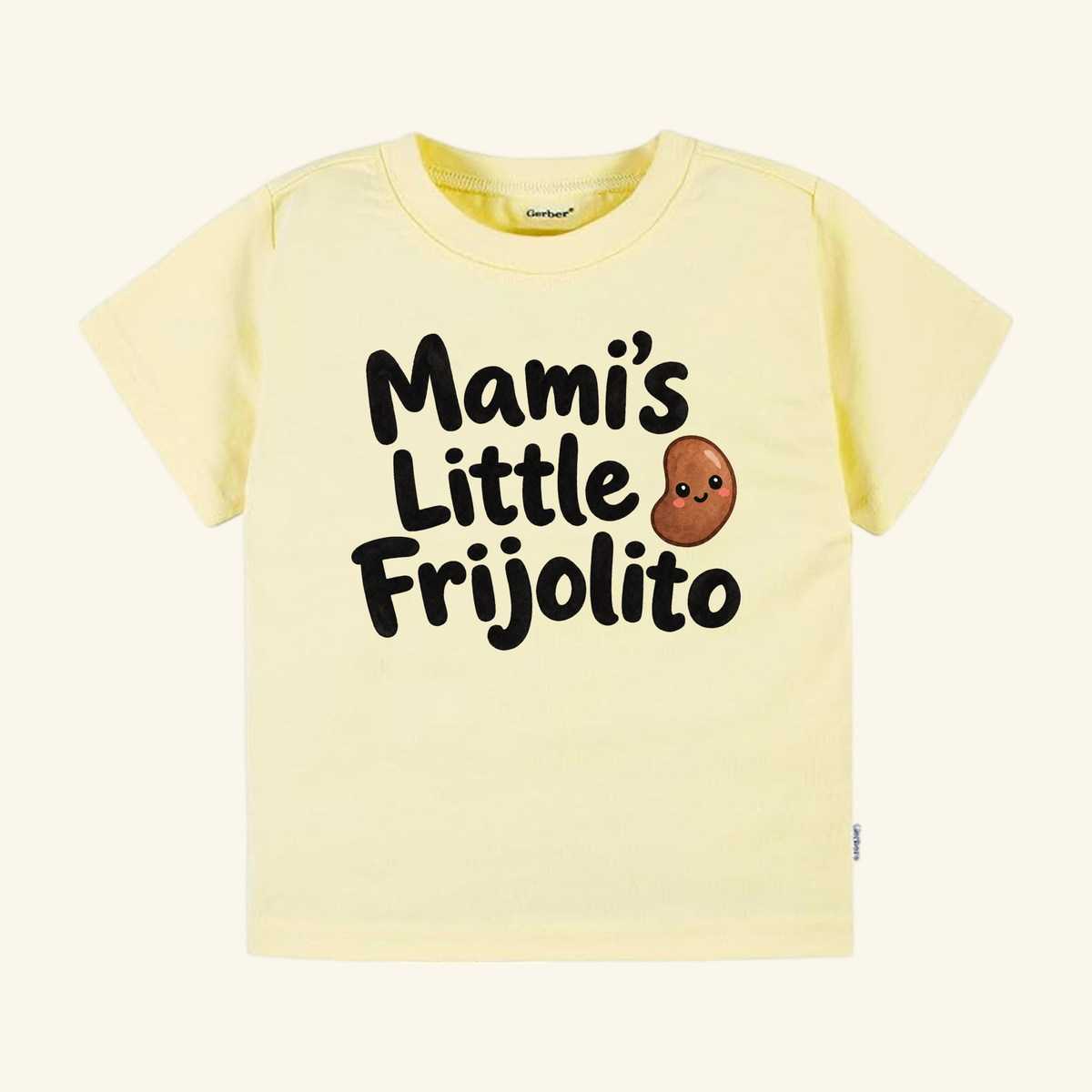 Pale yellow Mami’s Little Frijolito Toddler Shirt – Cute Spanish Bean Tee featuring a smiling cartoon bean and the text Mami’s Little Frijolito.