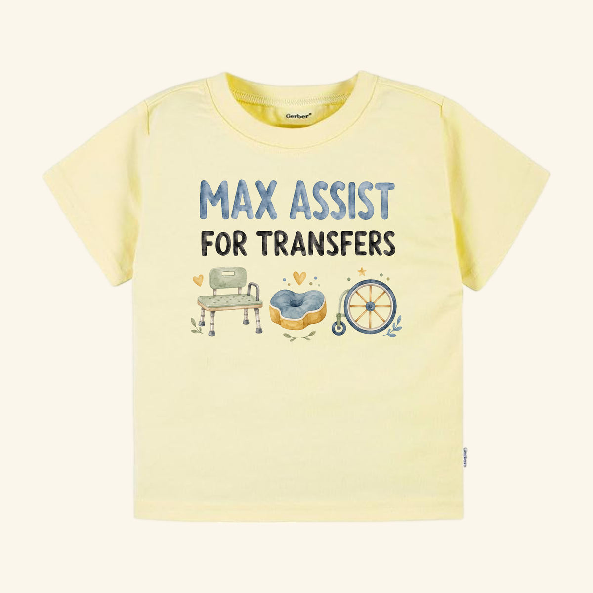 Pale yellow Max Assist for Transfers Toddler Shirt featuring the text MAX ASSIST FOR TRANSFERS above watercolor illustrations of a shower bench, a cushion, and a wheelchair.