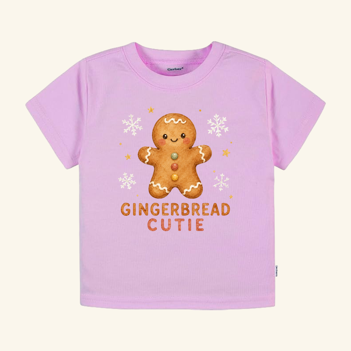 Light pink Gingerbread Cutie Toddler Shirt – Cute Christmas Gingerbread Man Tee featuring a gingerbread man graphic, snowflakes, and the text GINGERBREAD CUTIE.