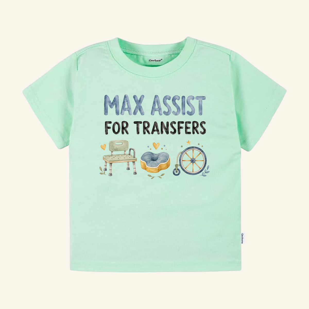 Mint green Max Assist for Transfers Toddler Shirt – Funny PT & OT Tee featuring the text MAX ASSIST FOR TRANSFERS above watercolor illustrations of a shower chair, a cushioned seat, and a wheelchair wheel.