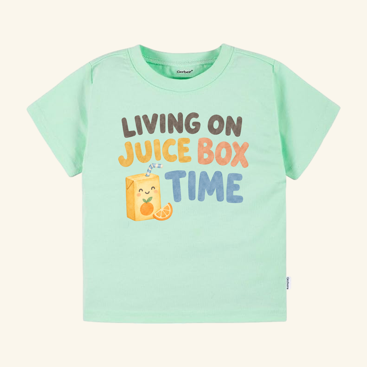 Light green Living on Juice Box Time Toddler Shirt featuring a smiling juice box illustration and the text Living on juice box time.