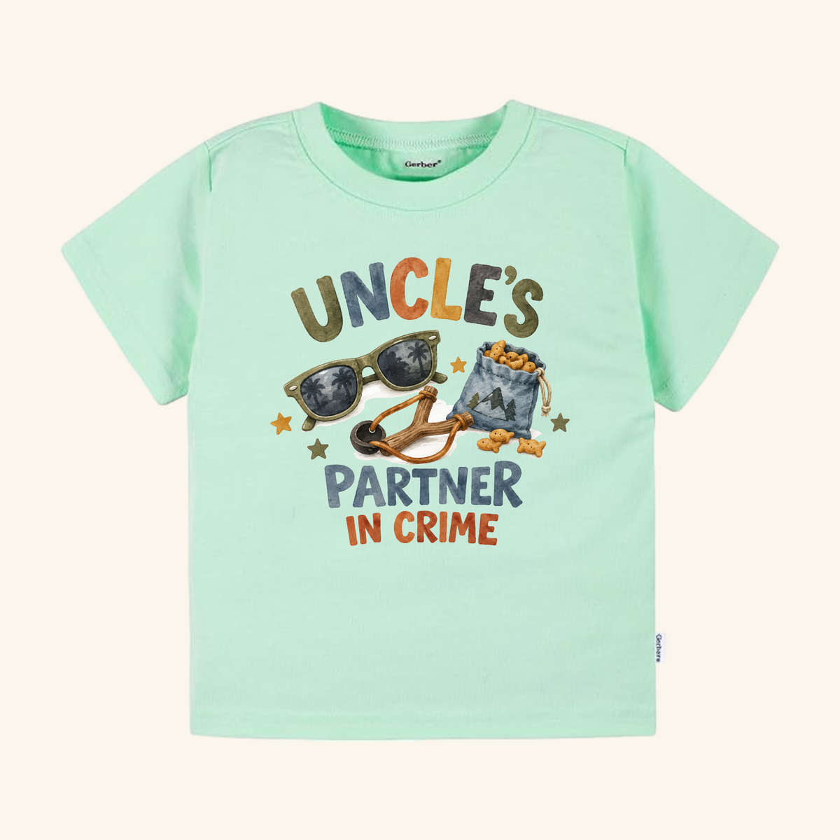 Mint green Funny Uncle Toddler Shirt – Uncle’s Partner in Crime Tee featuring the text Uncle’s Partner in Crime alongside illustrations of sunglasses, a slingshot, and a snack bag.