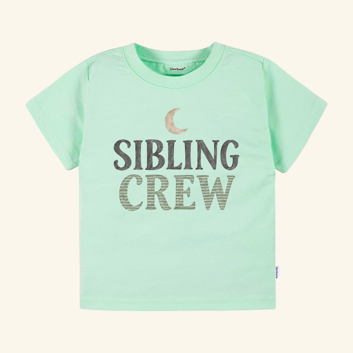 Light green short-sleeve Sibling Crew Toddler Shirt – Moon Matching Sibling Tee featuring a crescent moon icon and the text SIBLING CREW in dark letters.