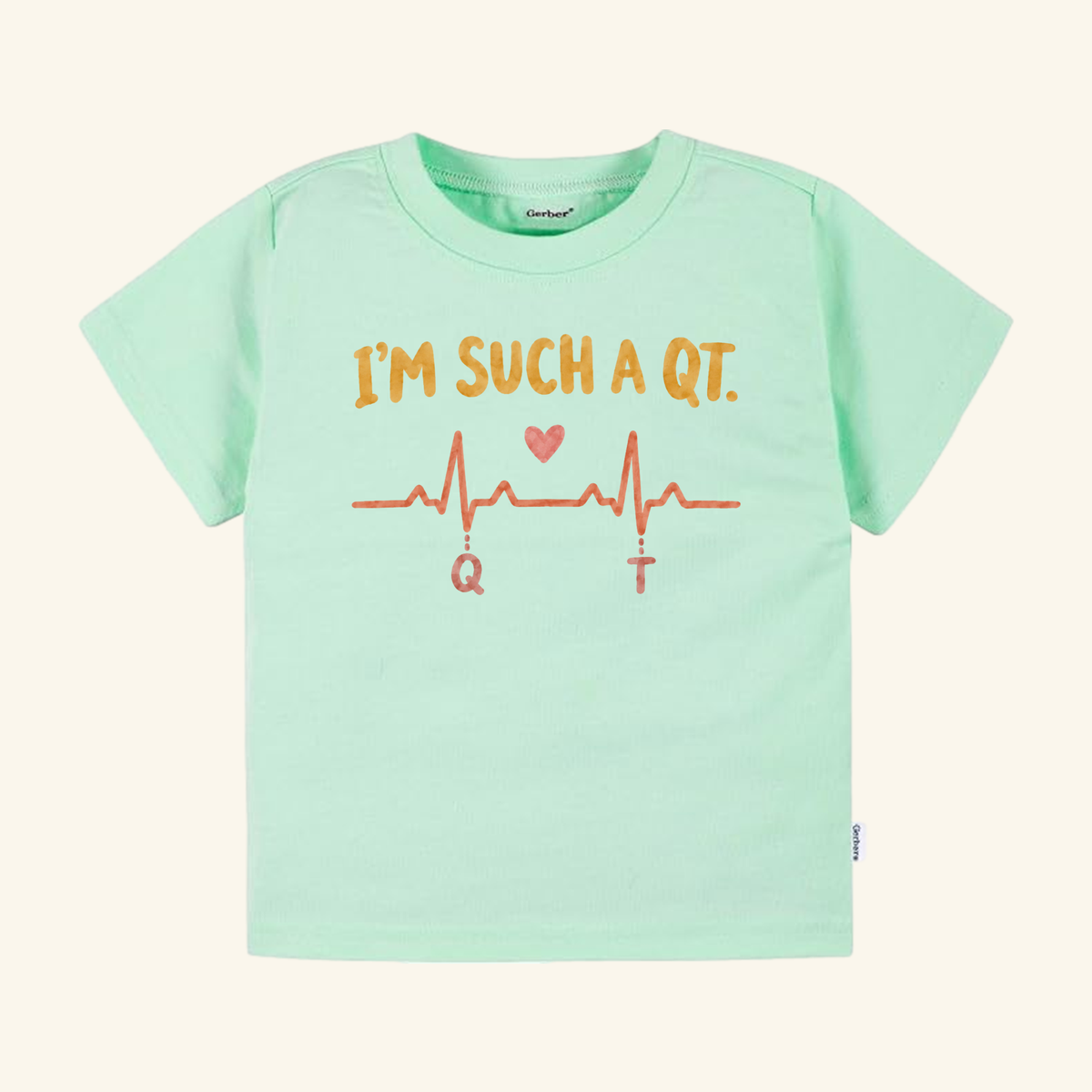 Mint green I’m Such a QT Toddler Shirt featuring an EKG heartbeat line with a small heart and the letters Q and T below the peaks.