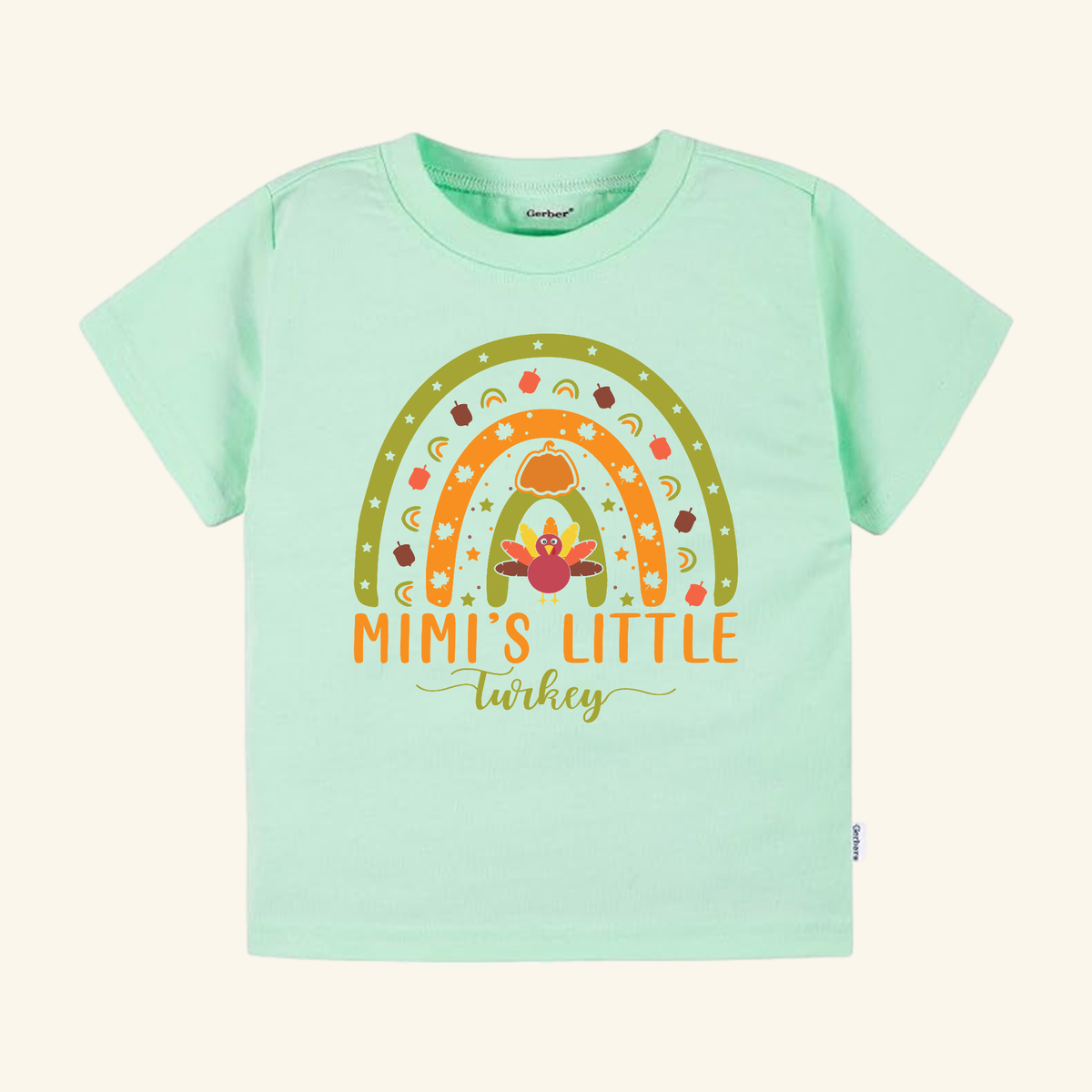 Mint green Mimi’s Little Turkey Toddler Shirt – Grandma Thanksgiving Rainbow Tee featuring a rainbow decorated with fall icons and a turkey graphic.