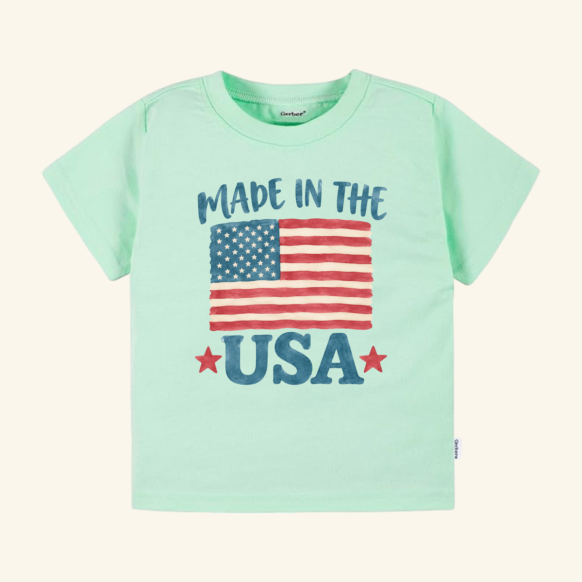 Light green Made in the USA Toddler Shirt – Patriotic American Flag Tee with a graphic of an American flag and the text MADE IN THE USA featuring two red stars.